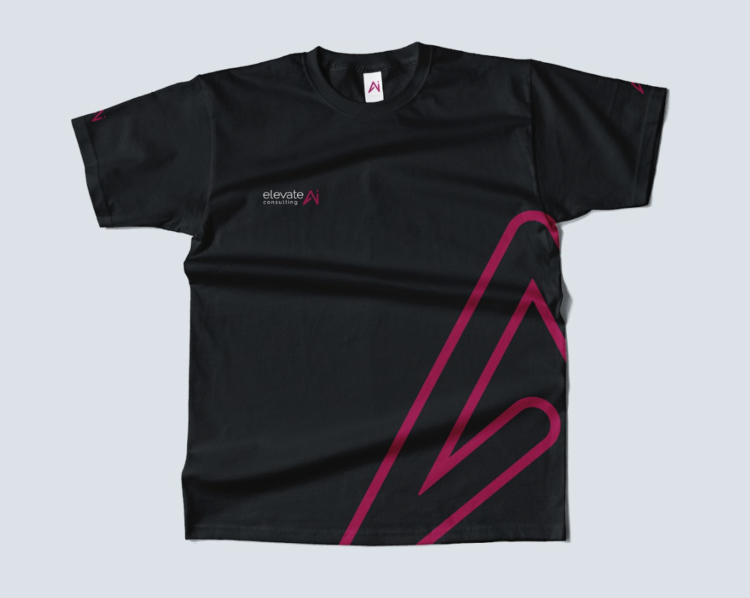 Elevate AI Consulting 2026 rebrand branded t-shirt for eMerge Americas: magenta AI arrow, full logo on chest, AI icons on sleeves — Diogo Carrilho design